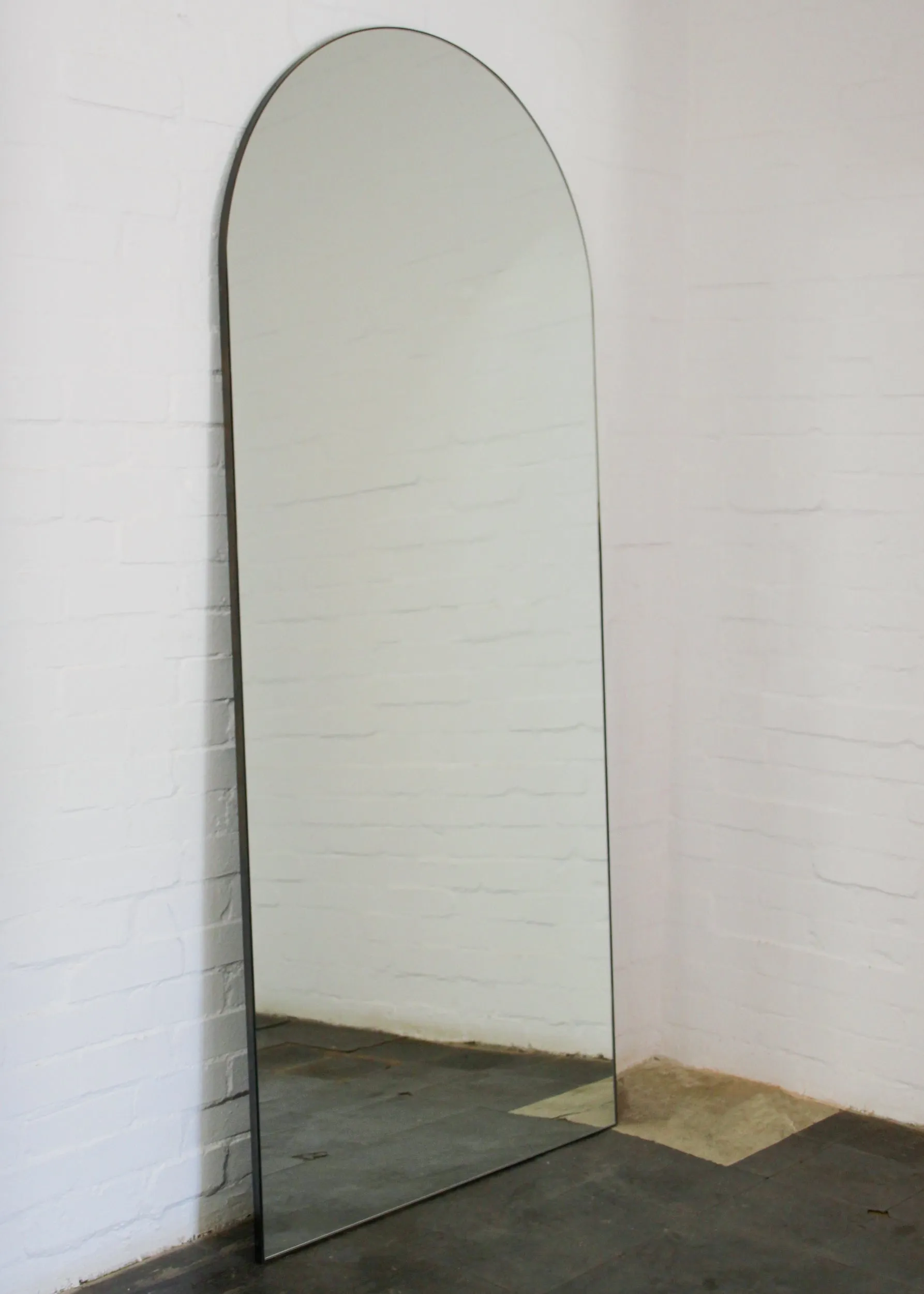 Arcus™ Arch shaped Oversized Wall-leaning Modern Mirror with a Brass Frame